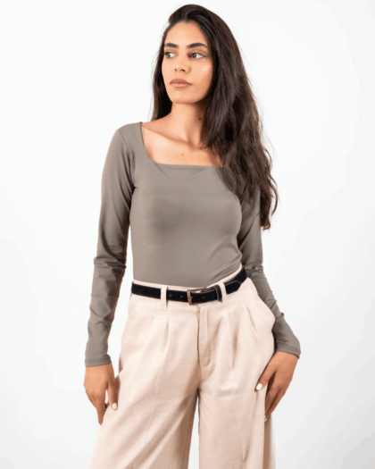 Model wearing a green square top in a standing pose, showcasing the front design.