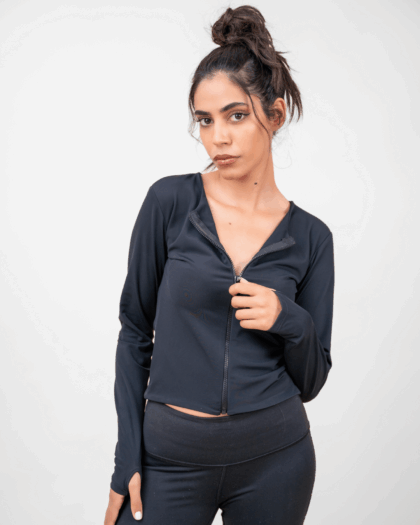 Model wearing a black zip top in a standing pose, showcasing the front design.