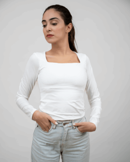 Model wearing a white square top in a standing pose, showcasing the front design.