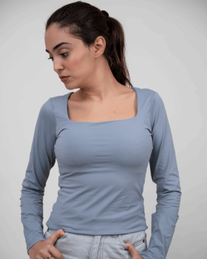 Model wearing a grey square top in a standing pose, showcasing the front design.